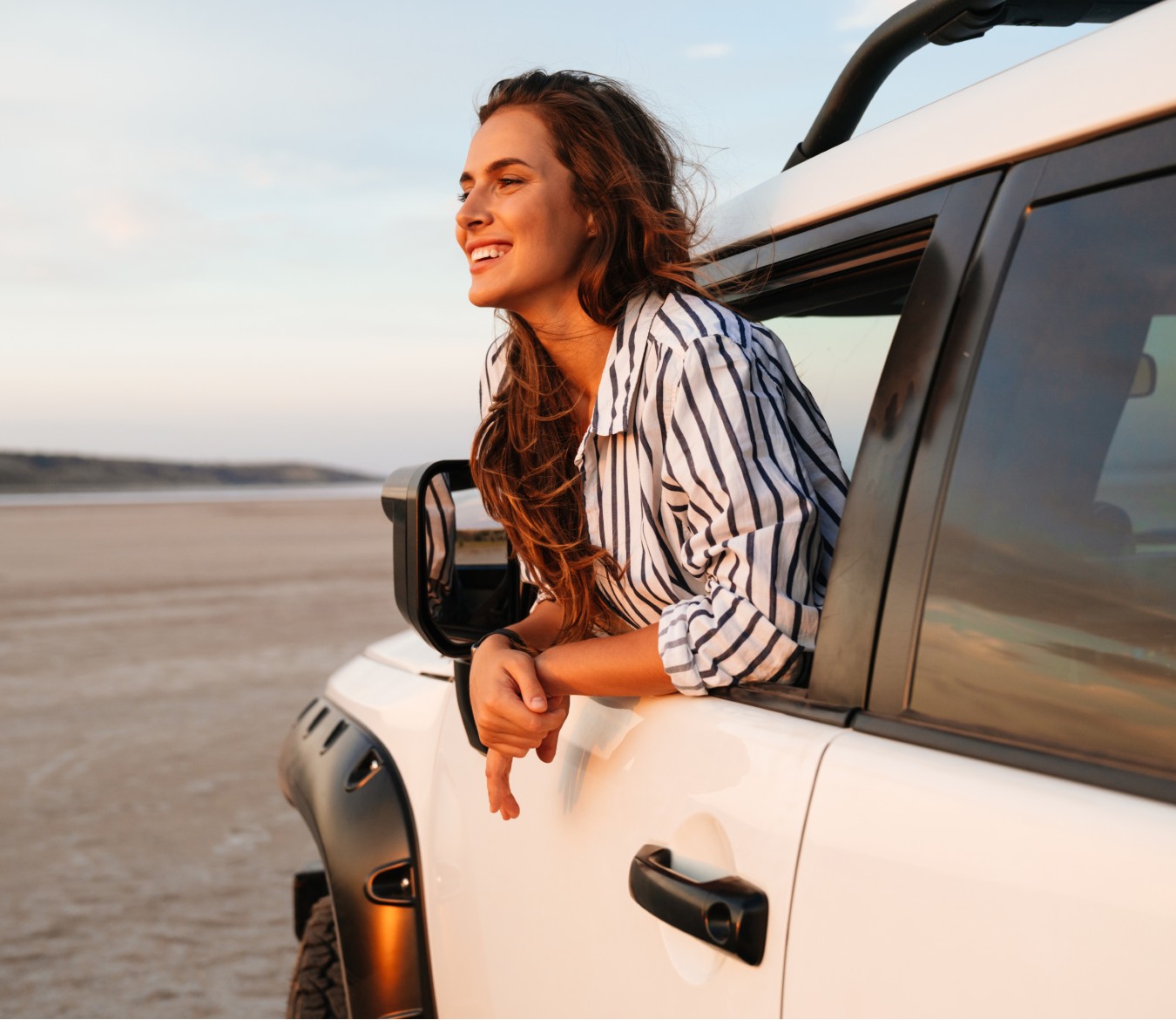 woman looking out window of car