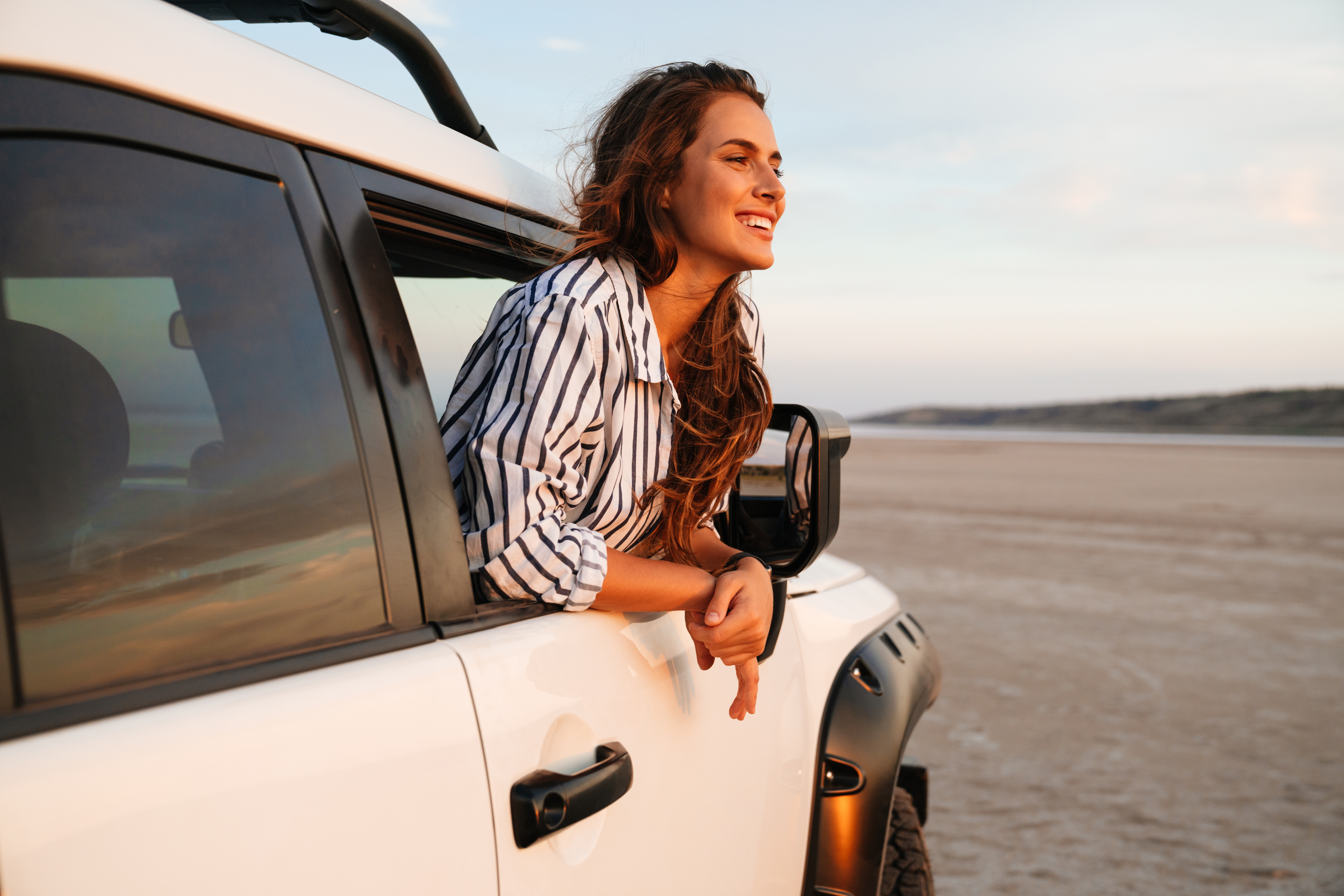 woman looking out window of car